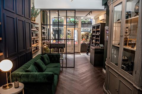 Interior of War Paint for Men on London's Carnaby Street featuring products on display and a green velvet sofa